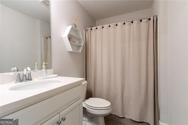 bathroom with toilet, vanity, tile patterned flooring, and curtained shower