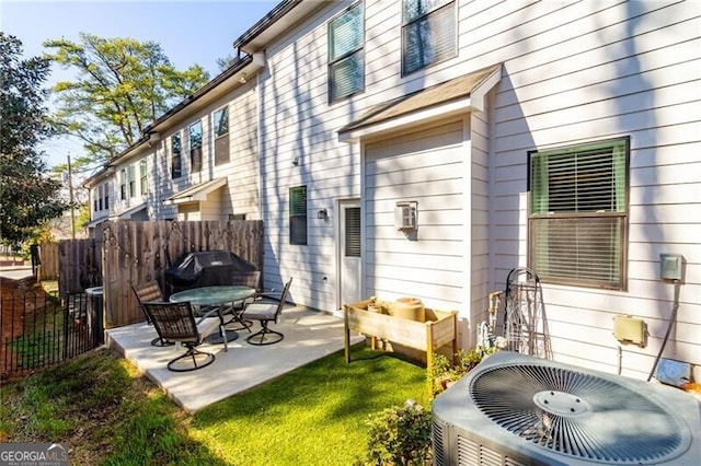 back of house featuring a patio area, cooling unit, and a lawn