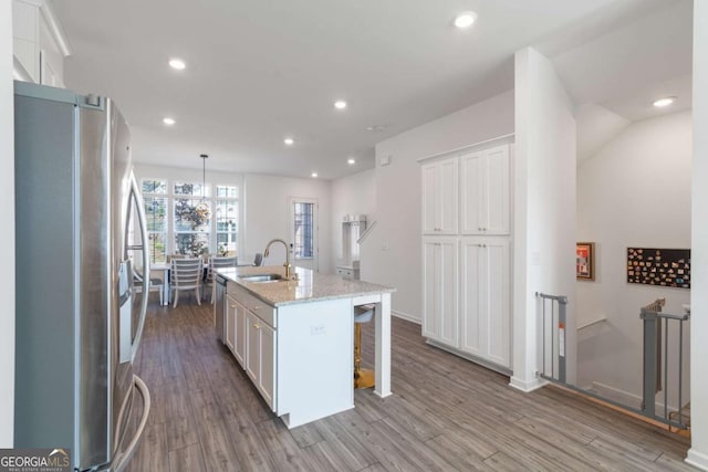 kitchen featuring an island with sink, appliances with stainless steel finishes, white cabinetry, and sink