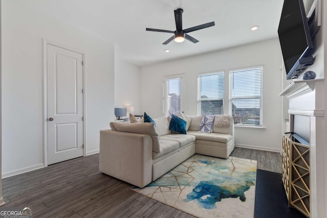 living room featuring dark hardwood / wood-style flooring and ceiling fan