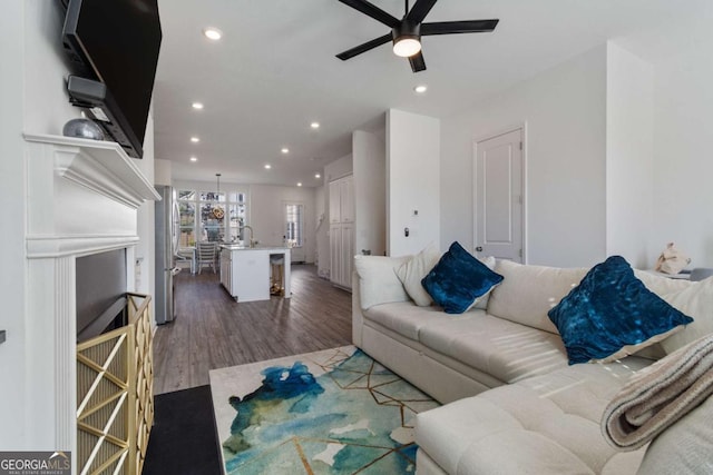 living room with ceiling fan and dark hardwood / wood-style floors