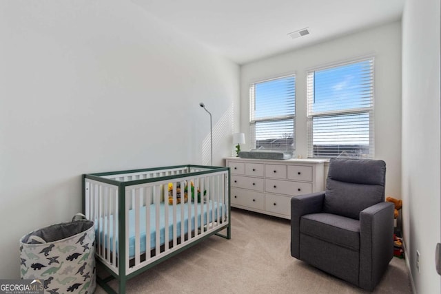 carpeted bedroom with a crib