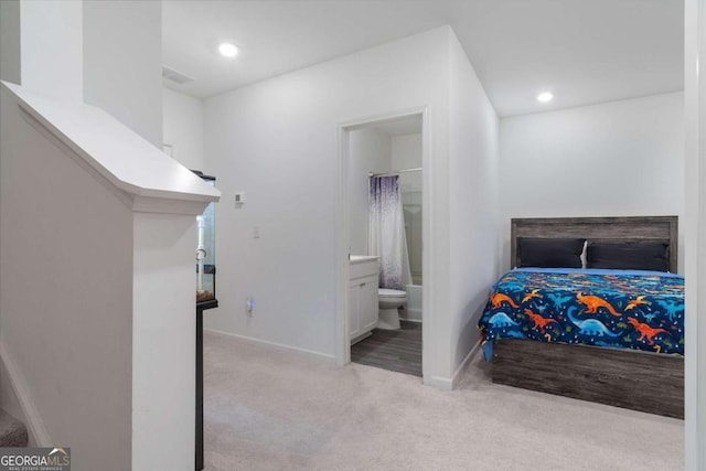 carpeted bedroom featuring ensuite bathroom