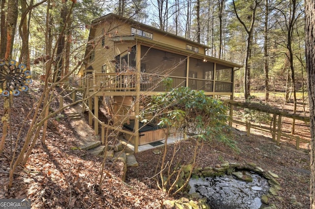 view of property exterior with a sunroom