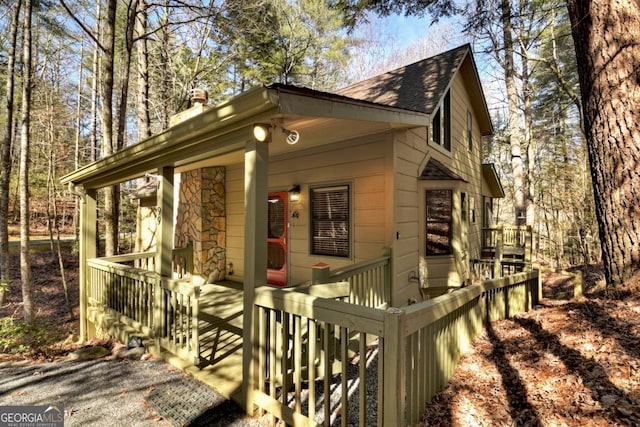 view of front of property featuring roof with shingles