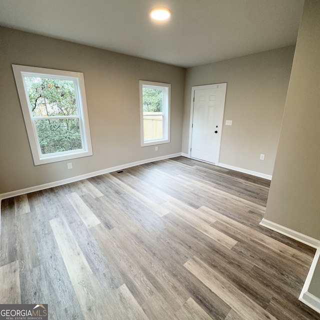 unfurnished room with light hardwood / wood-style flooring