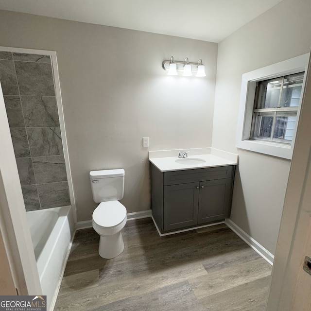 bathroom with toilet, hardwood / wood-style flooring, and vanity