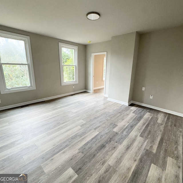 empty room with light hardwood / wood-style flooring