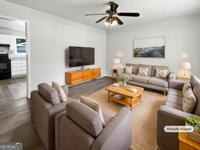 living room with dark wood-style floors, ceiling fan, and baseboards