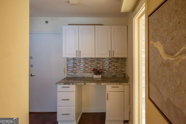 kitchen with white cabinets, dark wood-type flooring, and backsplash