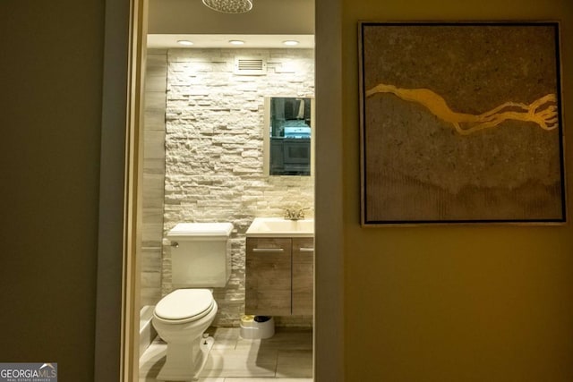 bathroom with tile patterned flooring, vanity, and toilet