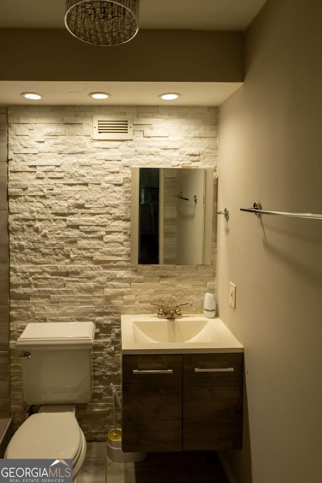 bathroom featuring vanity and toilet