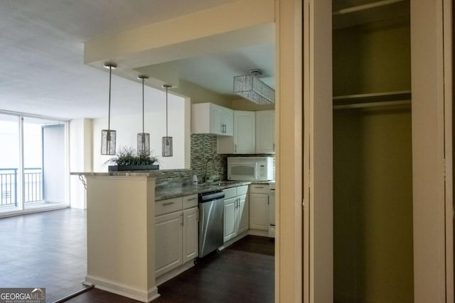 kitchen with white cabinetry, kitchen peninsula, backsplash, dishwasher, and pendant lighting