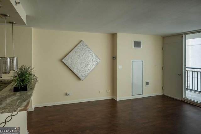 empty room with dark wood-type flooring