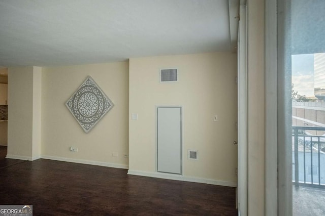 empty room with dark hardwood / wood-style flooring