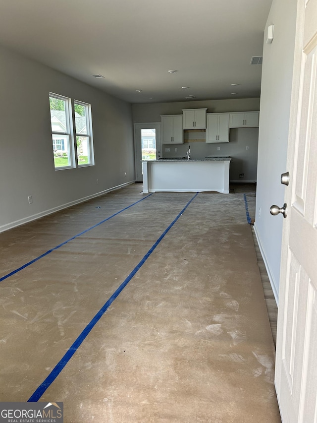 9 Wildflower Ln Unit 41, Dallas, GA 30132 - unfurnished living room with baseboards and a sink
