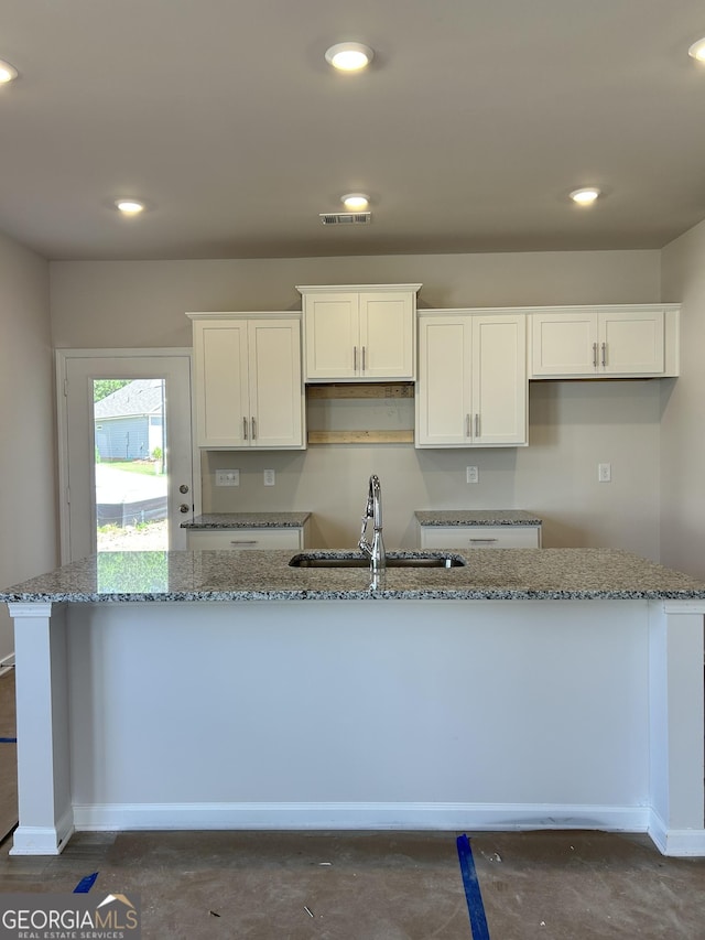 9 Wildflower Ln Unit 41, Dallas, GA 30132 - kitchen featuring a sink, white cabinets, stone counters, concrete floors, and recessed lighting