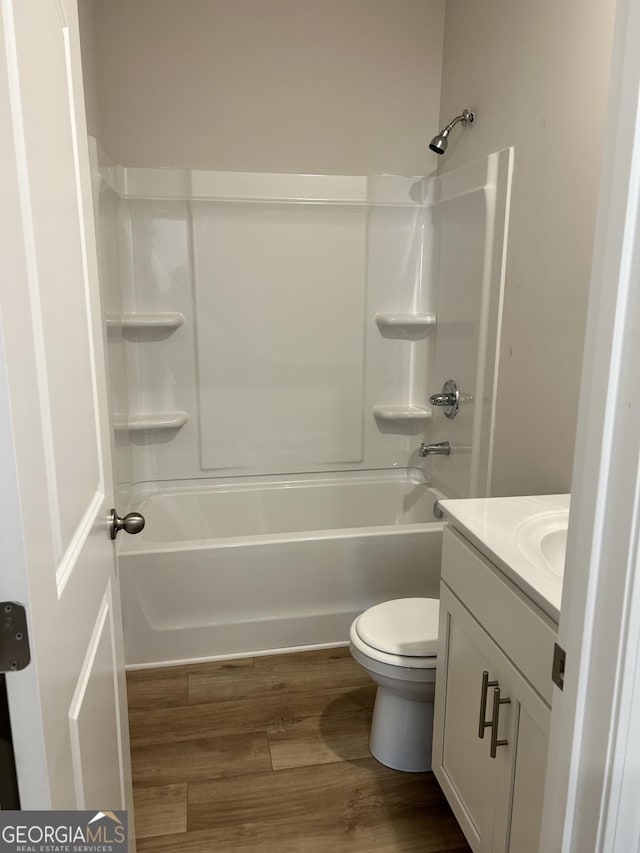 9 Wildflower Ln Unit 41, Dallas, GA 30132 - bathroom featuring vanity, toilet, washtub / shower combination, and wood finished floors