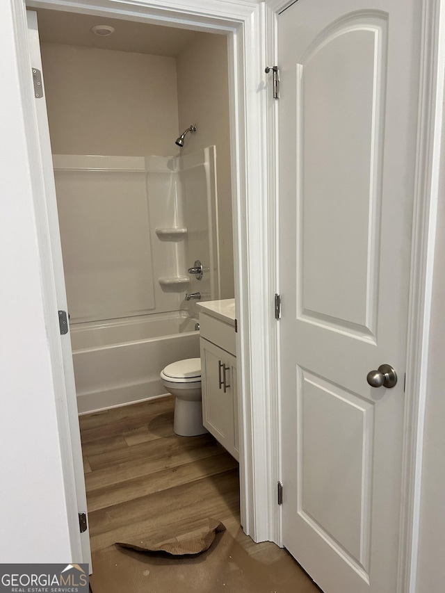 9 Wildflower Ln Unit 41, Dallas, GA 30132 - bathroom with vanity, toilet, shower / bathtub combination, and wood finished floors