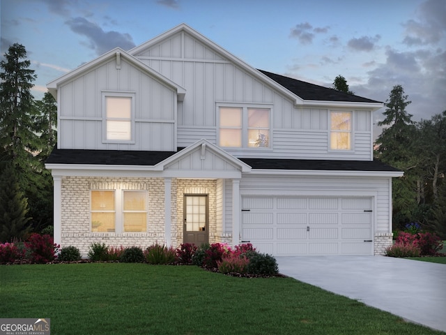 view of front of property with a front yard and a garage