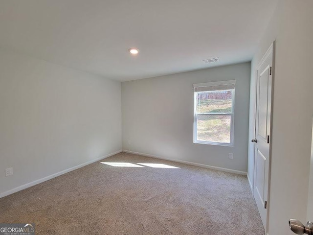 empty room featuring light colored carpet