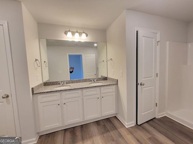 bathroom with vanity and wood-type flooring