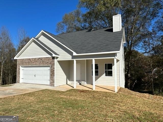 view of front of property with a garage and a front yard