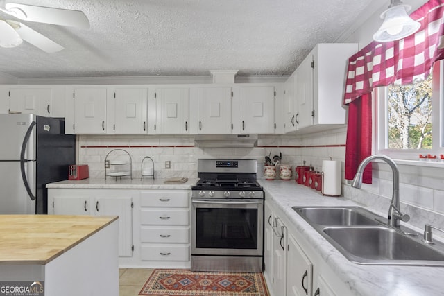 kitchen featuring white cabinetry, stainless steel appliances, tasteful backsplash, and sink