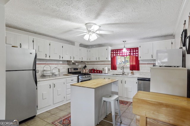 kitchen featuring white cabinetry, sink, a kitchen island, and stainless steel appliances