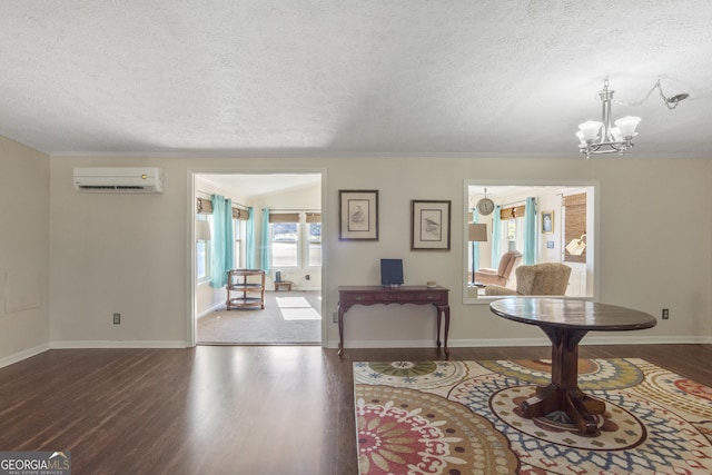 interior space featuring an AC wall unit, dark wood-type flooring, a textured ceiling, and a chandelier