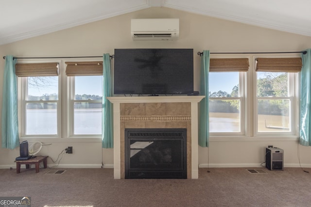 unfurnished living room with a wall mounted air conditioner, a tiled fireplace, carpet flooring, and vaulted ceiling