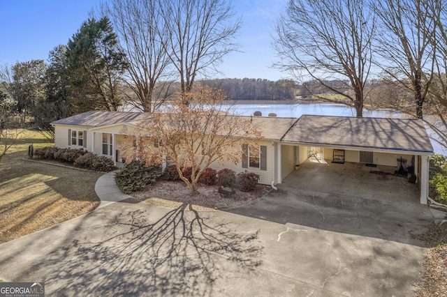 ranch-style house featuring a water view and a carport