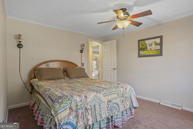 bedroom featuring a textured ceiling, carpet floors, and ornamental molding