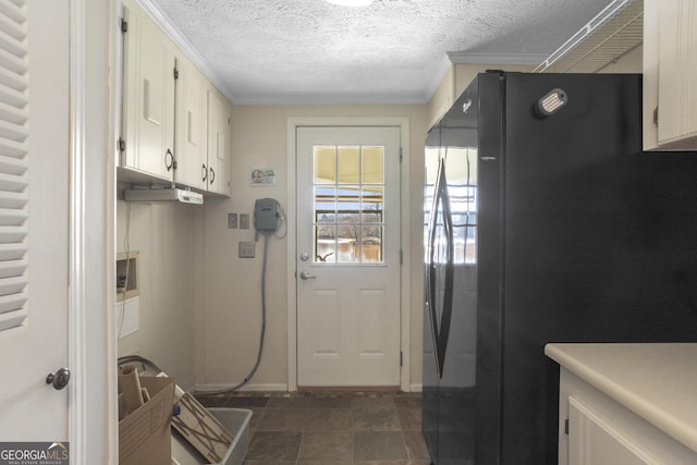 interior space with cabinets, a textured ceiling, and ornamental molding