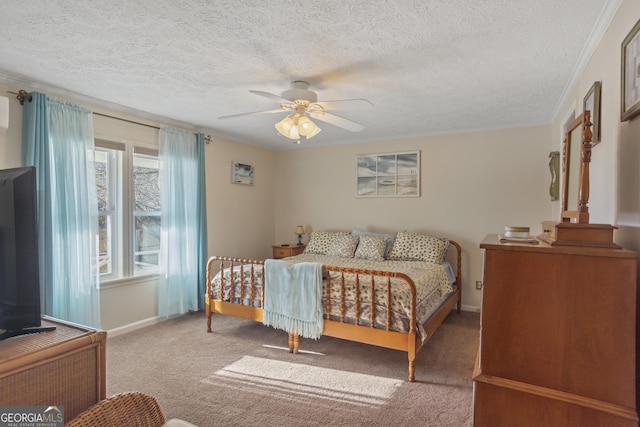 carpeted bedroom featuring a textured ceiling, ceiling fan, and ornamental molding