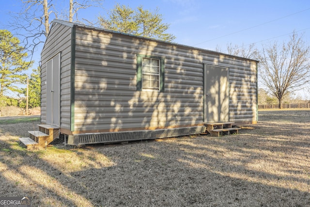 view of outbuilding with a yard