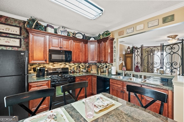 kitchen featuring dark stone countertops, sink, crown molding, black appliances, and decorative backsplash