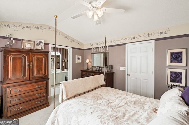 carpeted bedroom with lofted ceiling and ensuite bath