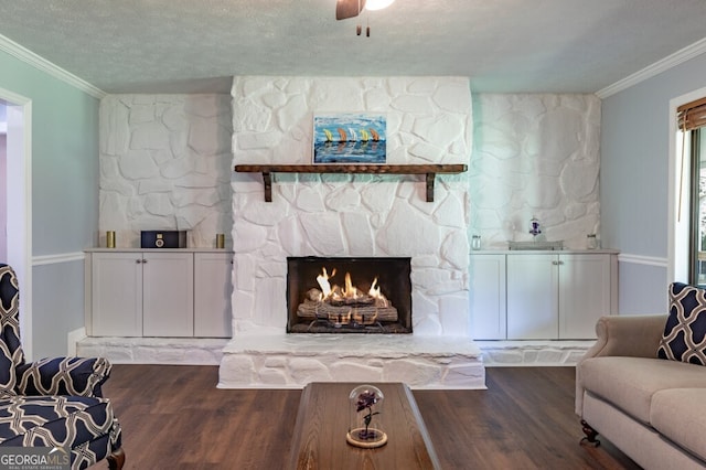 living room featuring a fireplace, crown molding, a textured ceiling, and dark hardwood / wood-style flooring