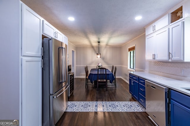 kitchen with stainless steel appliances, white cabinets, decorative light fixtures, blue cabinets, and dark hardwood / wood-style floors