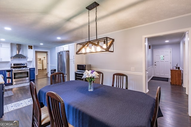 dining area with recessed lighting, ornamental molding, and dark wood-style flooring