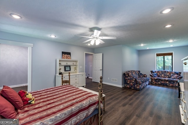 bedroom featuring ceiling fan, dark wood-type flooring, and a textured ceiling