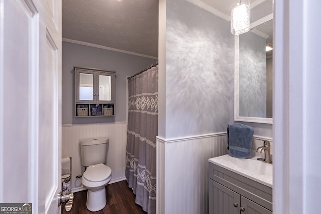 bathroom with hardwood / wood-style floors, vanity, toilet, and ornamental molding