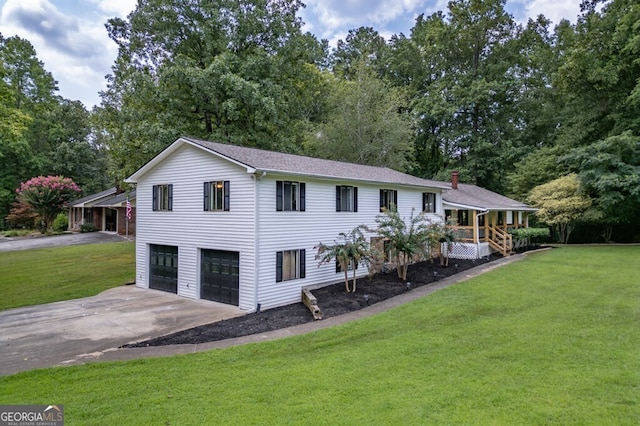 split level home featuring concrete driveway, an attached garage, and a front yard