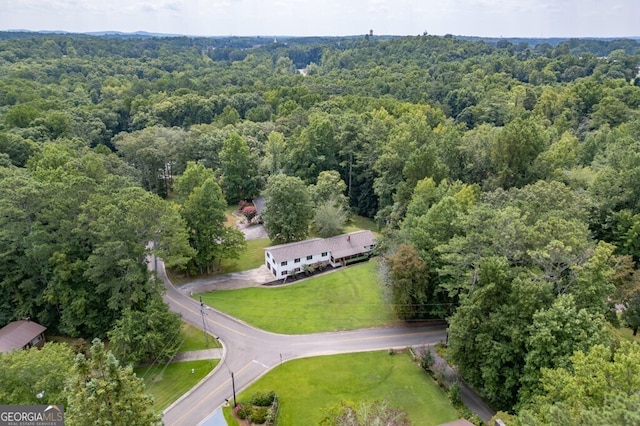 drone / aerial view with a wooded view