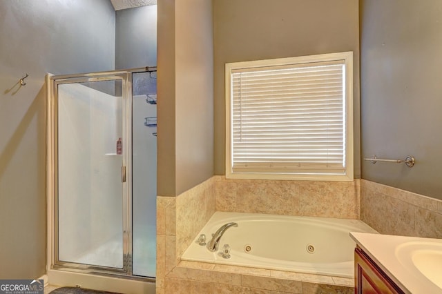 bathroom featuring a stall shower, vanity, and a tub with jets