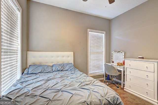 bedroom with light carpet and a ceiling fan