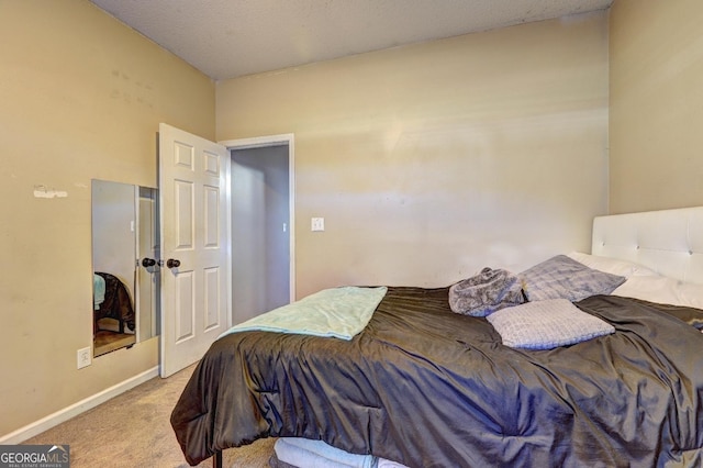 bedroom featuring baseboards and light colored carpet