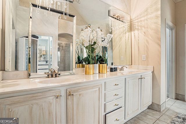 bathroom with vanity, vaulted ceiling, an enclosed shower, and tile patterned floors