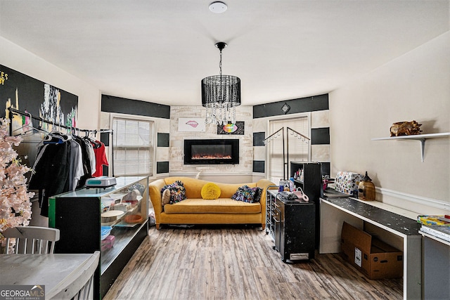 living room with an inviting chandelier and wood-type flooring